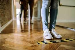 people standing distanced in line